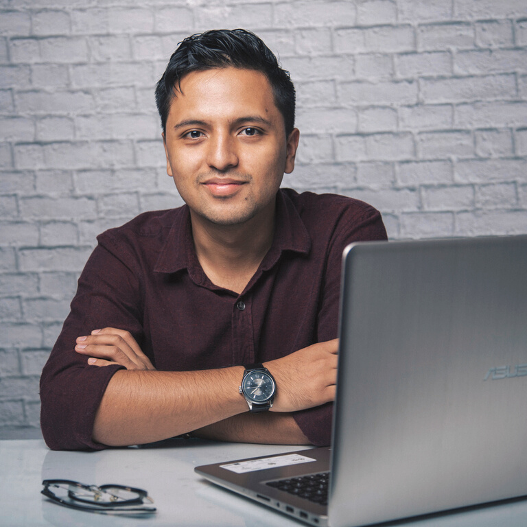 Smiling man with laptop and eyeglasses